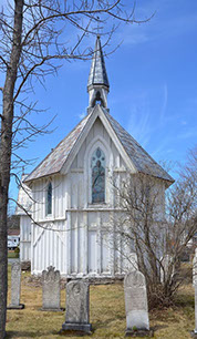 A white church with a steeple

Description automatically generated